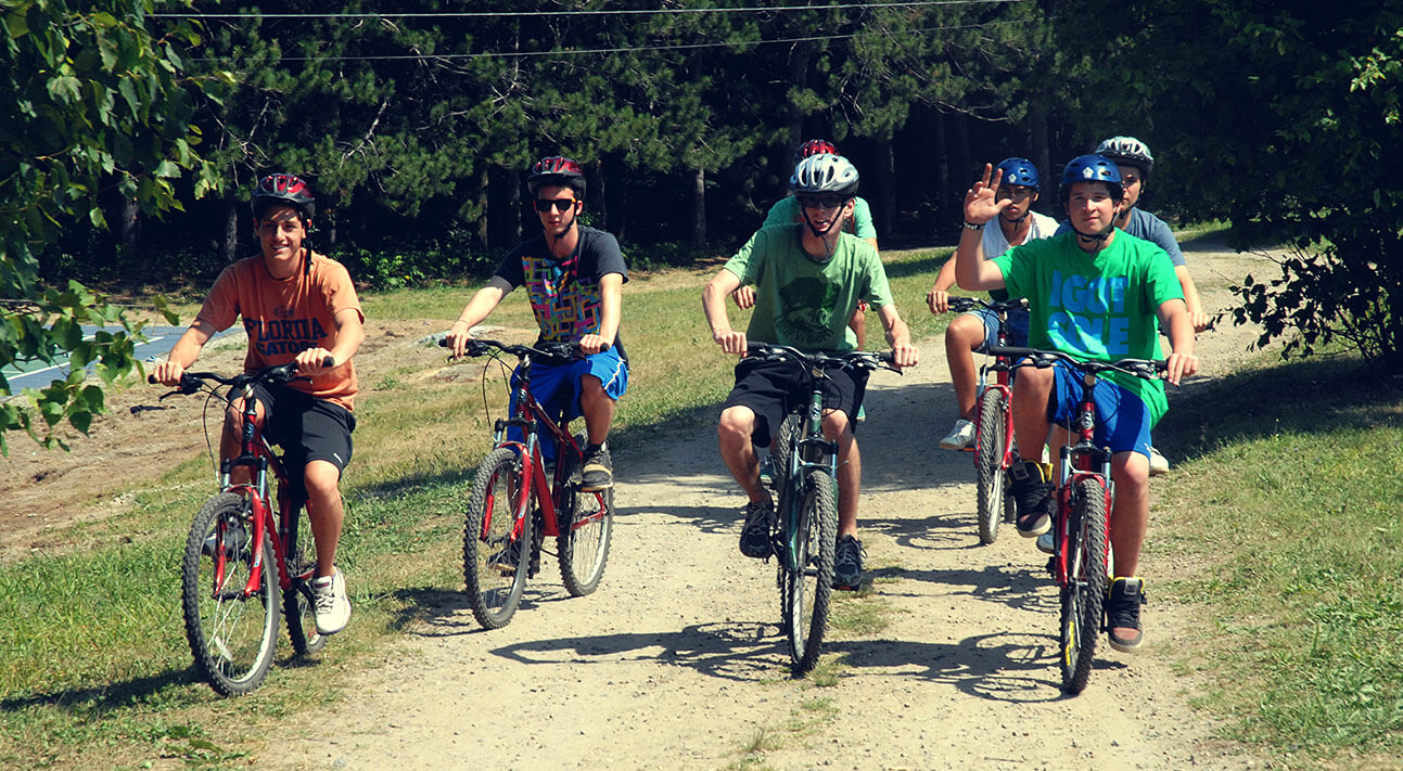 A group of boys riding bicycles